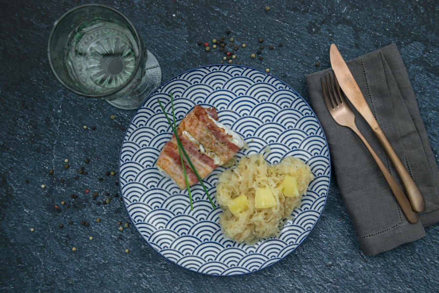 Pikeperch wrapped in bacon served on pineapple slaw