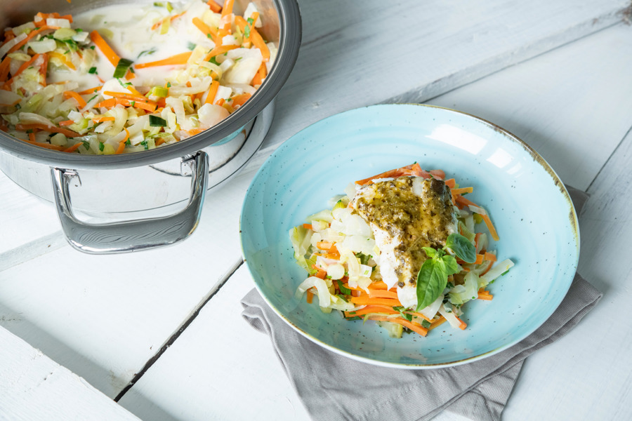 Herby fish filet on julienned vegetables