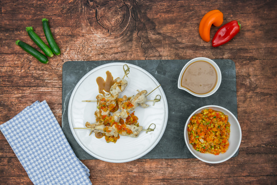 Colorful chicken skewers with peanut sauce